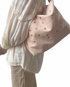 Leather bag with star embroidery.